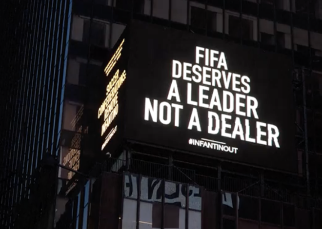 Times Square billboard screams for Infantino to go; FIFA boss ducks questions in Poland